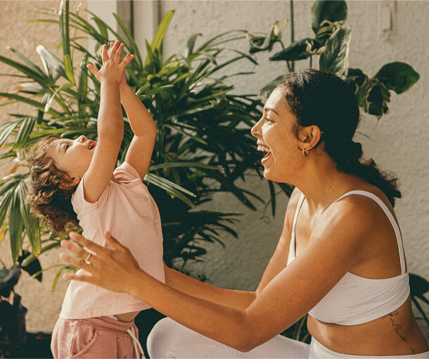 Mother smiles while playing with her child