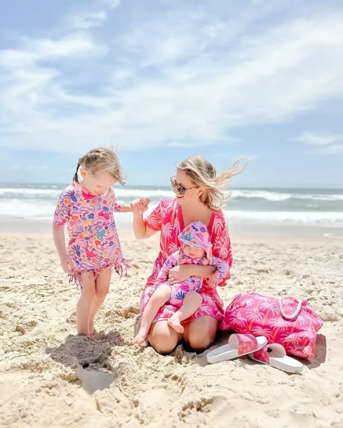 Happy Mom with 2 daughters in the beach